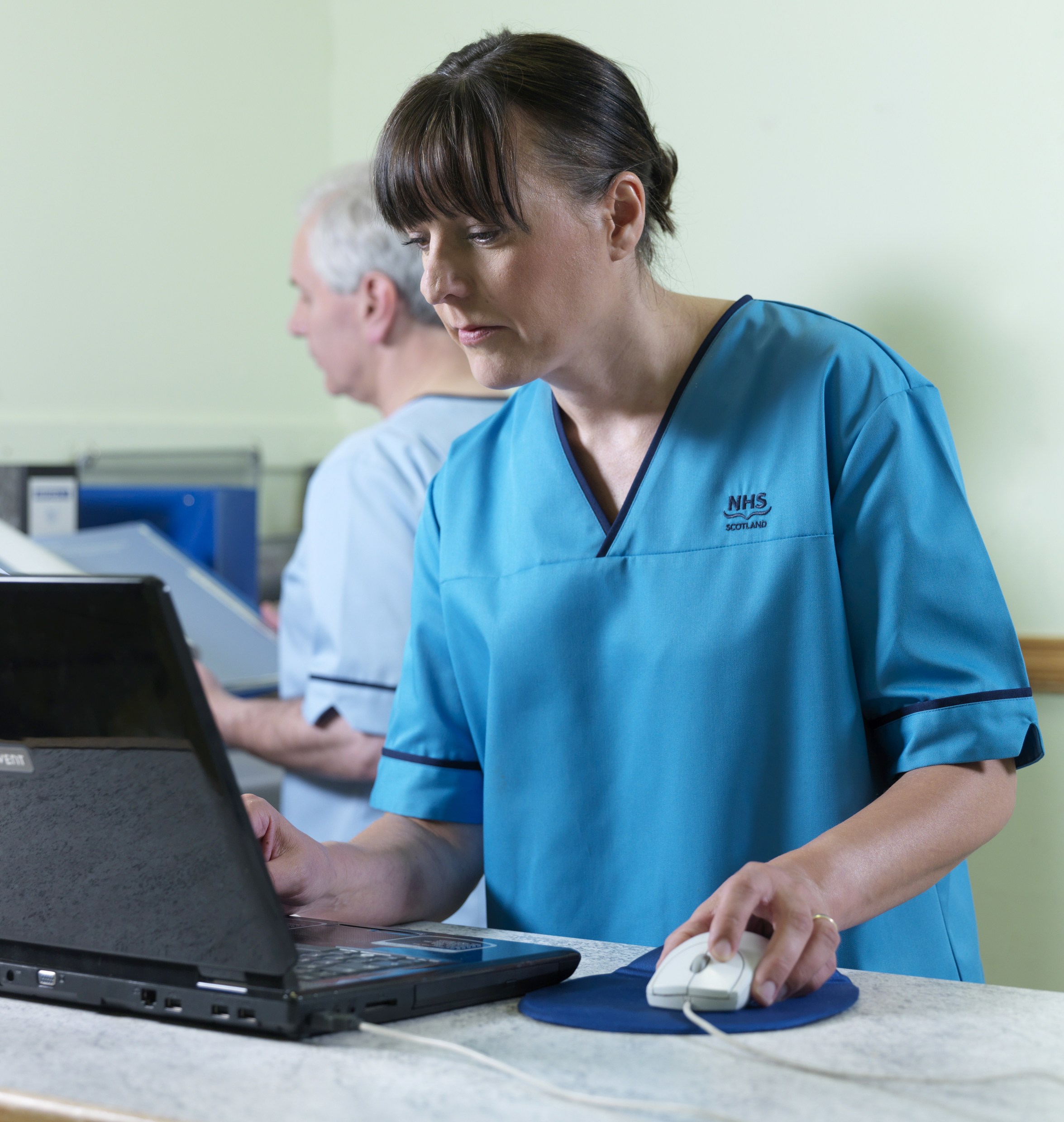 Nurse checking details on a computer